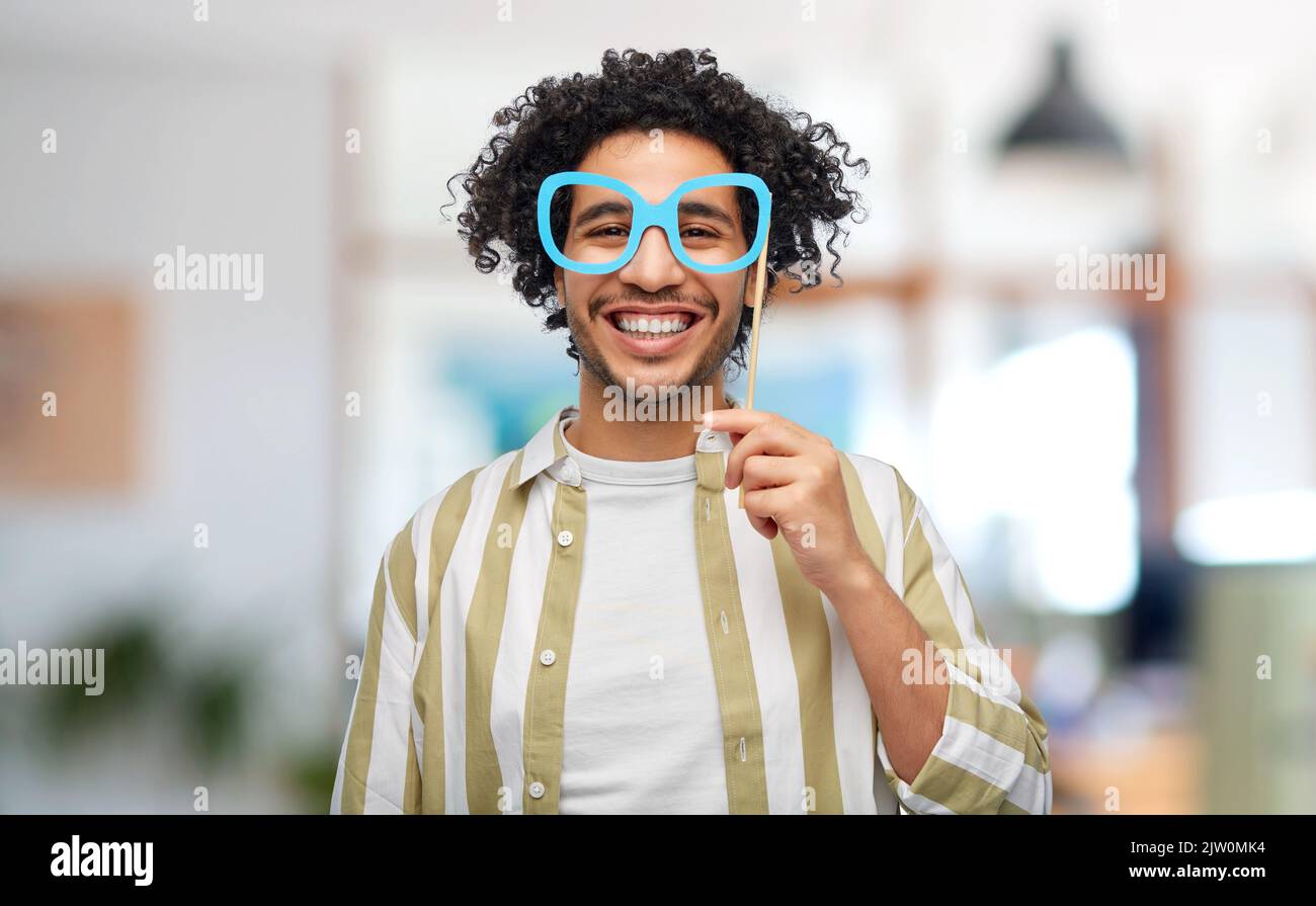 smiling man with glasses party accessory at office Stock Photo