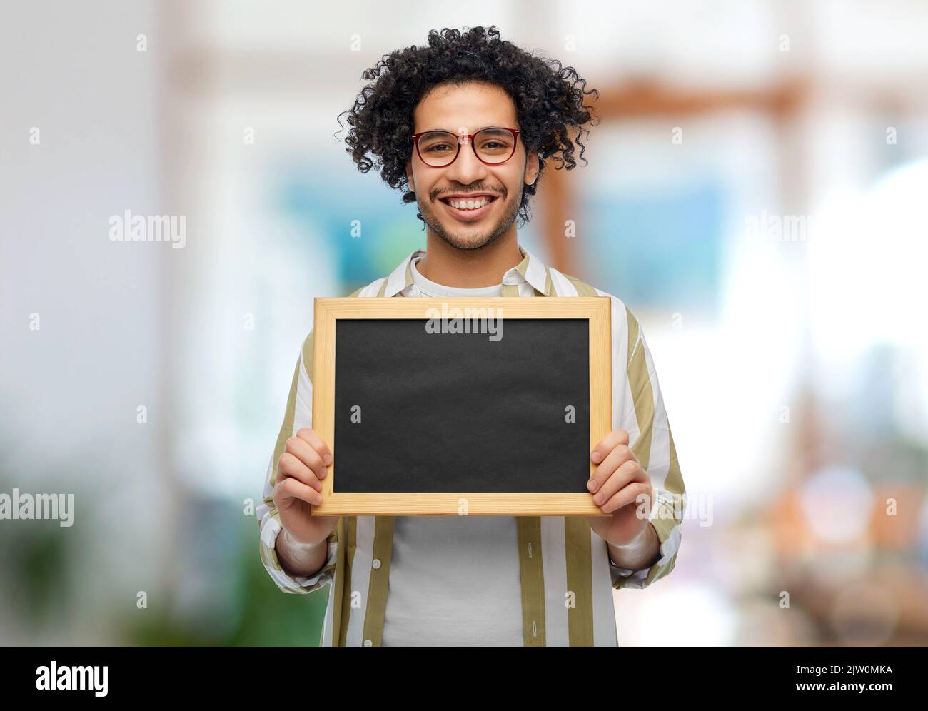smiling man with chalkboard at office Stock Photo