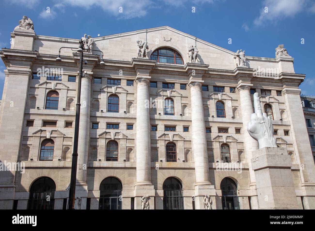 L.O.V.E. Sculpture by Maurizio Cattelan in front of the Milan stock exchange, Milan, Italy Stock Photo