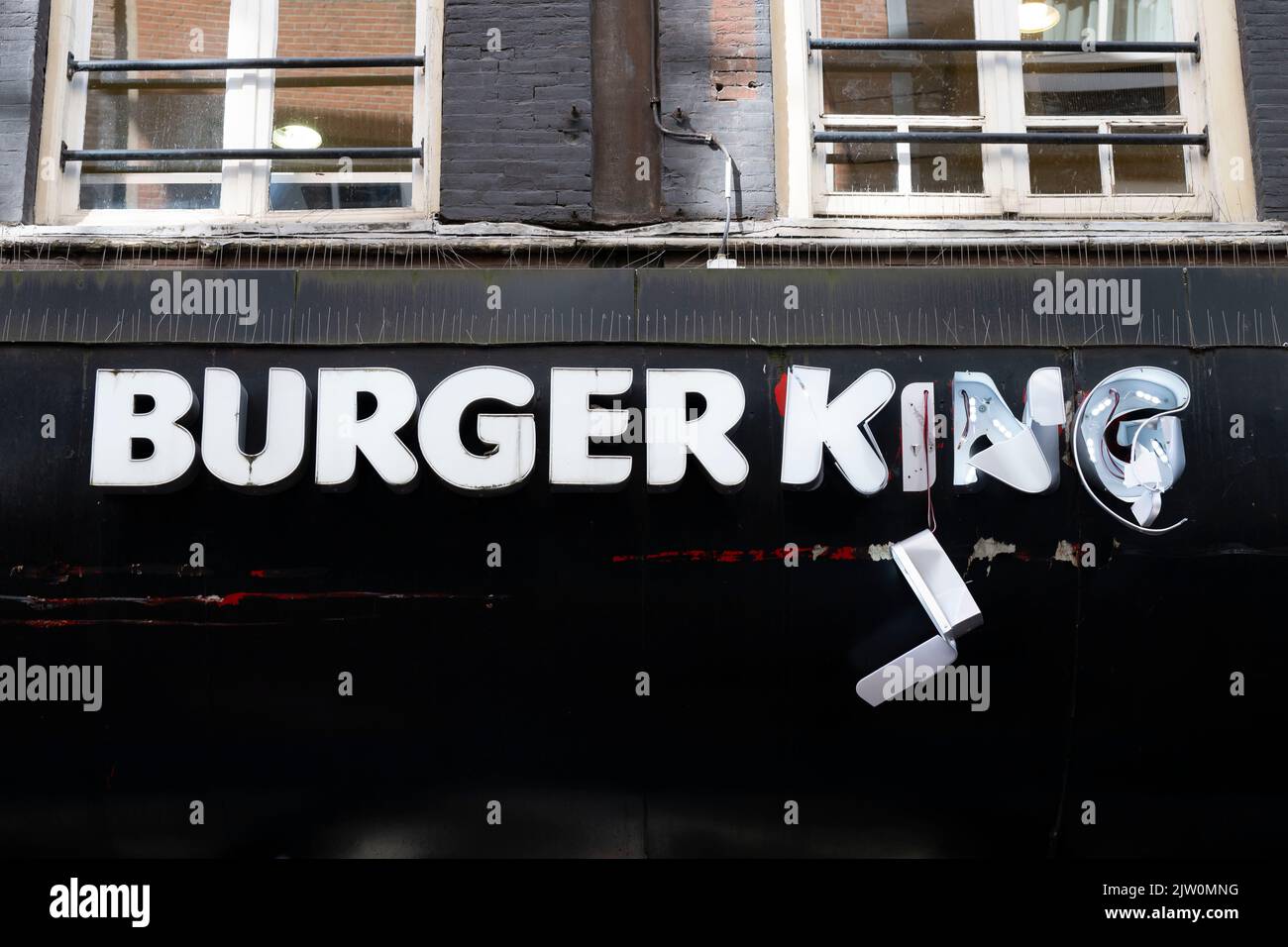 A damaged Burger King restaurant sign in Amsterdam, Holland. Stock Photo