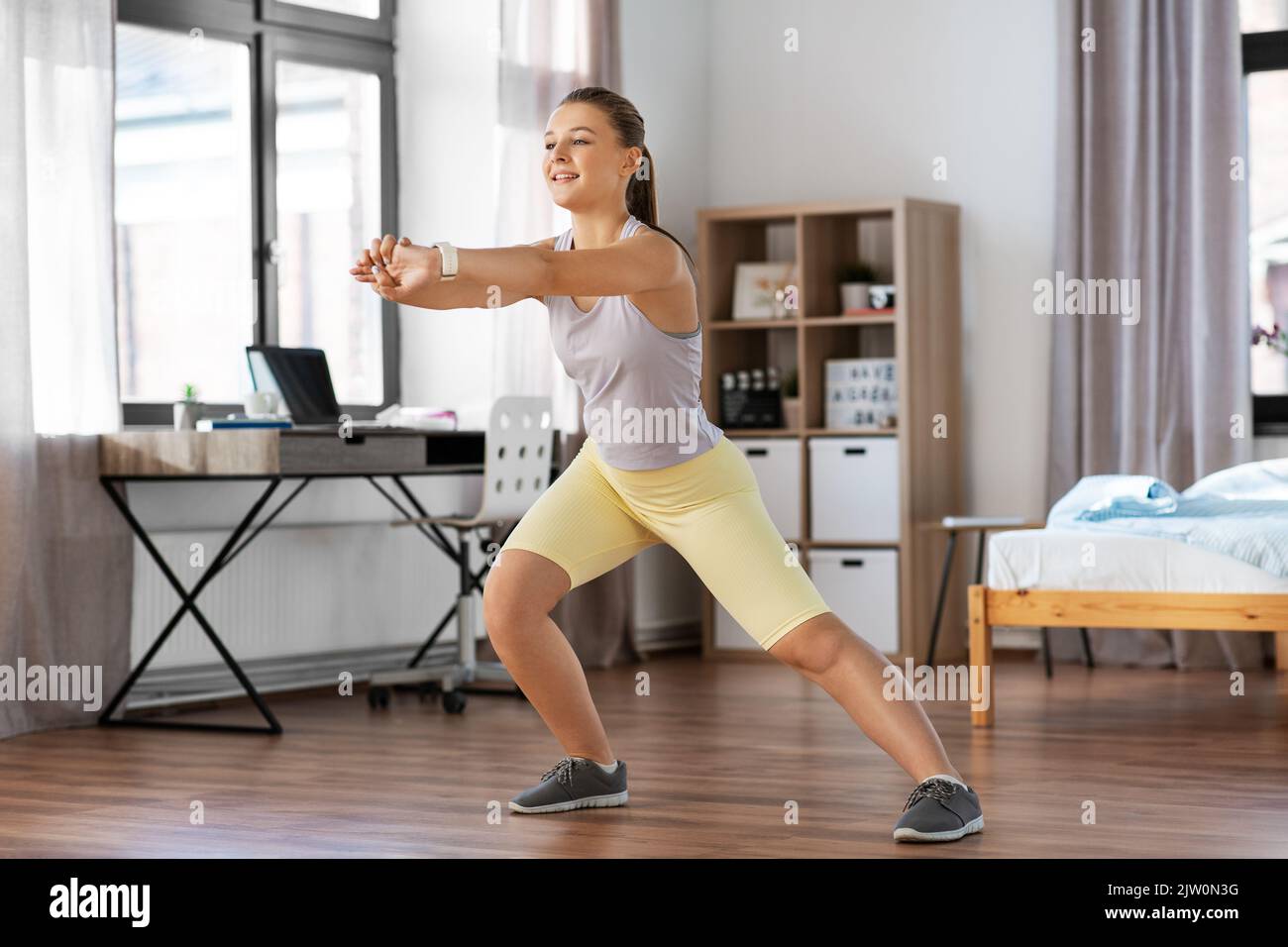 happy teenage girl exercising at home Stock Photo - Alamy