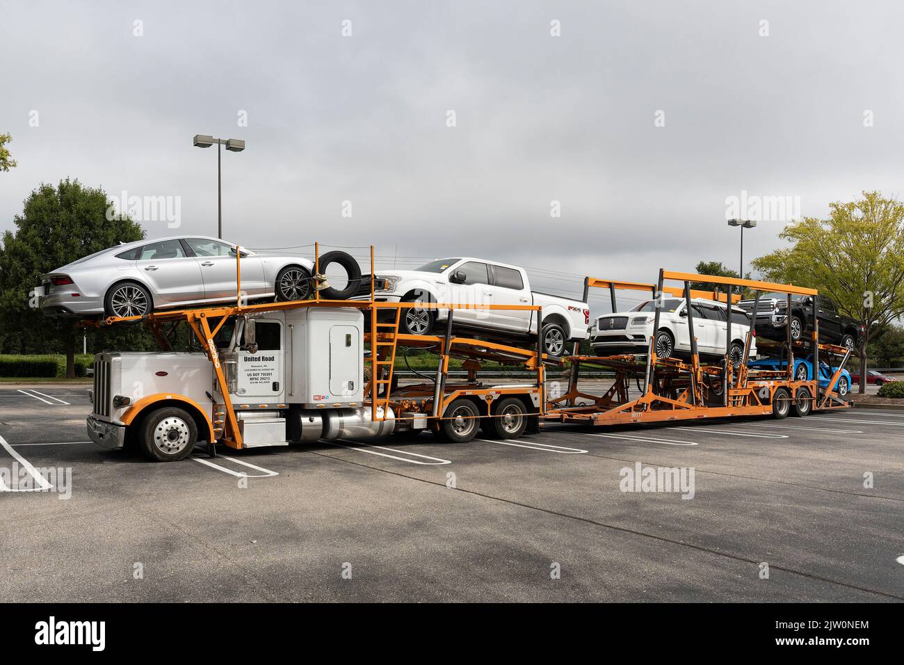 Large two level car carrier with cars and trucks ready for delivery in Montgomery Alabama, USA. Stock Photo