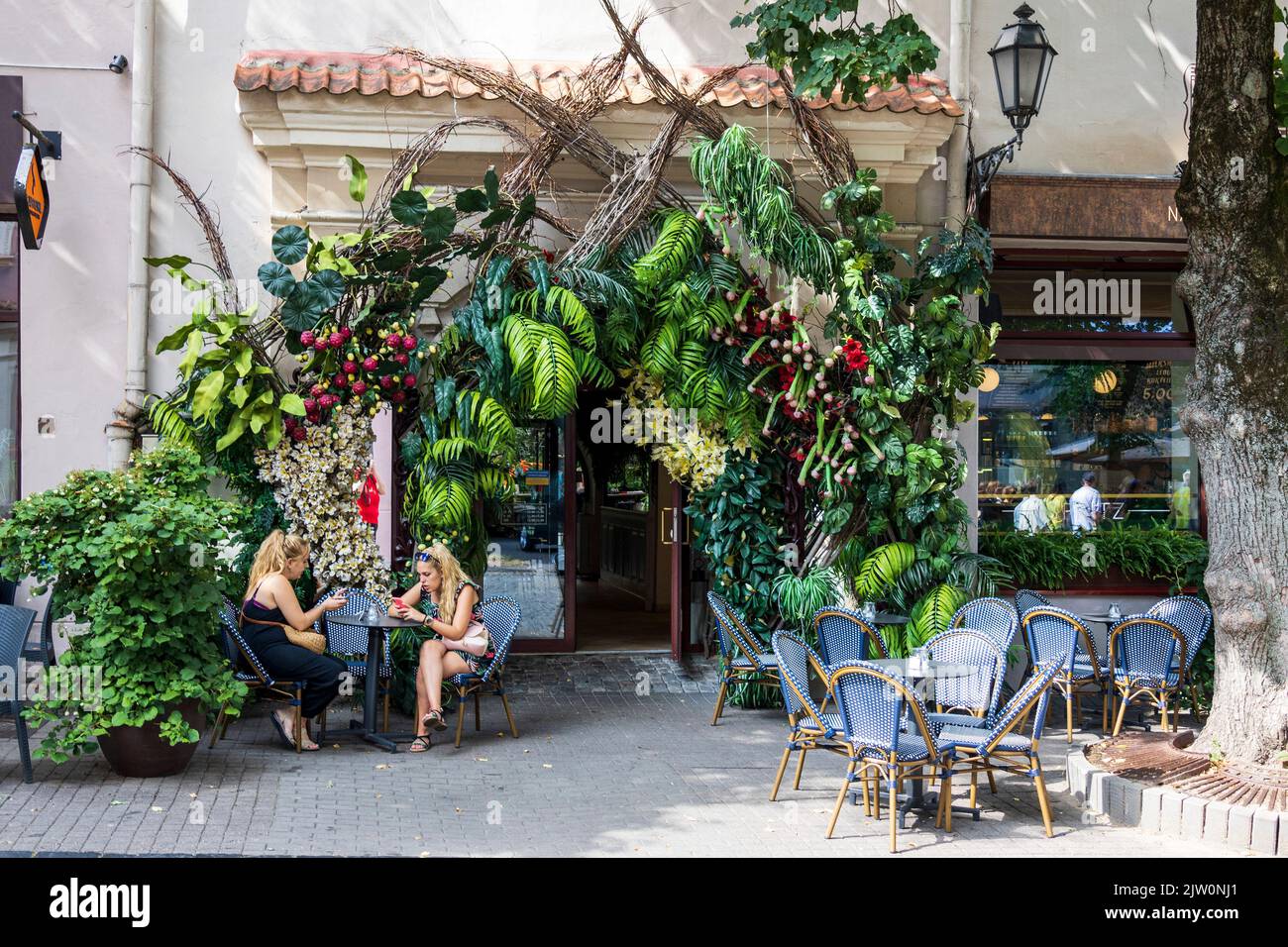 Outdoor seating area of a café with floral decorations in Vilnius, Lithuania, Baltics, Europe Stock Photo