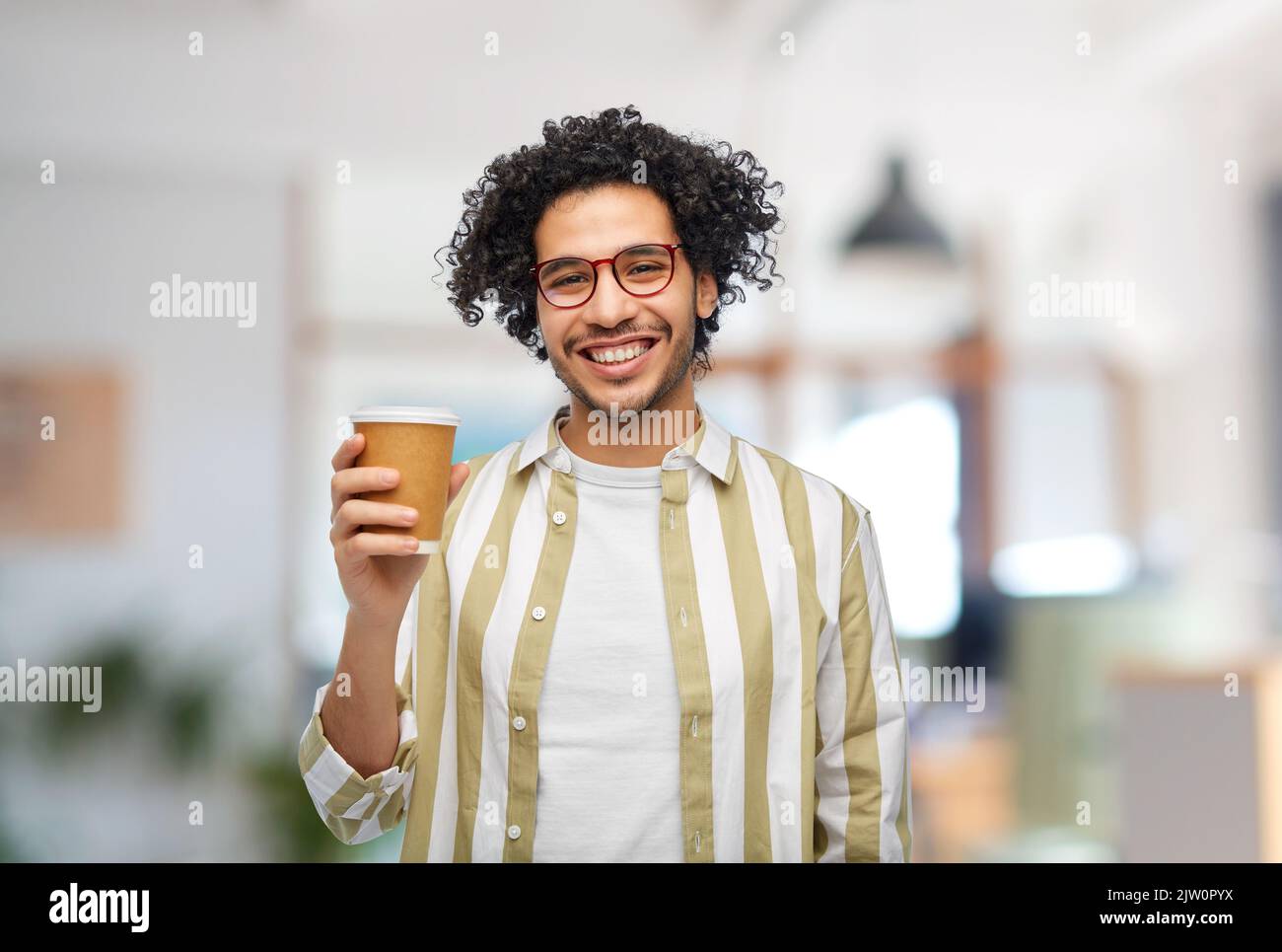 smiling man with takeaway coffee cup at office Stock Photo