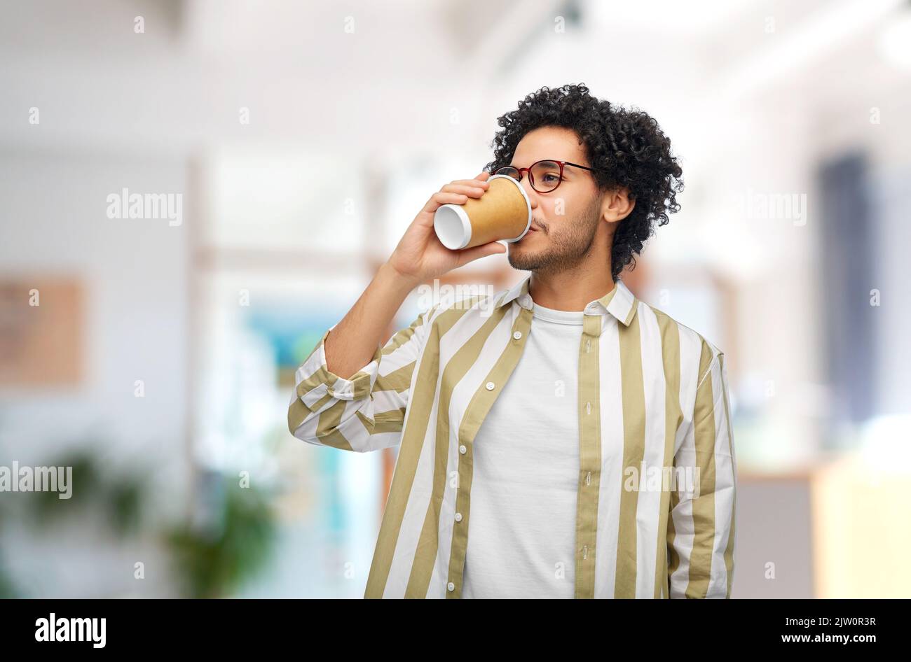 man drinking takeaway coffee at office Stock Photo