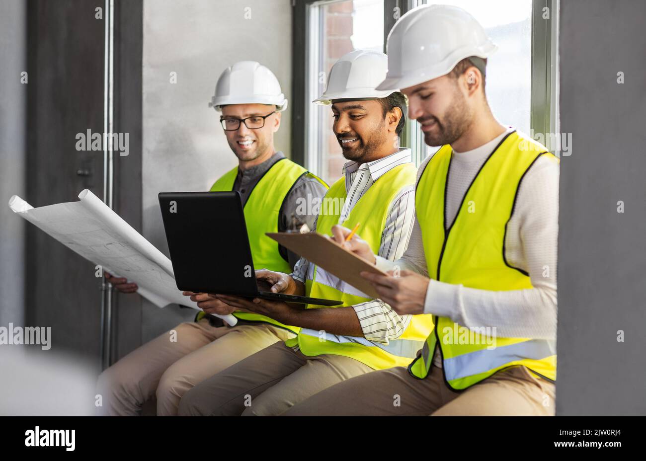 male architects in helmets working at office Stock Photo