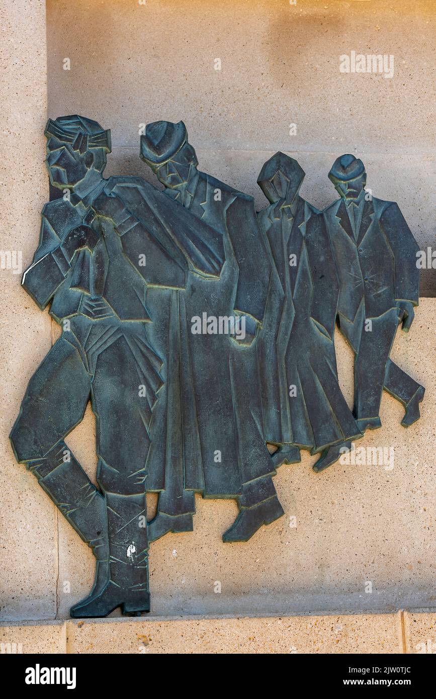 wall art sculpture in bronze of greek people working carrying bags during the invasion of crete in the second Stock Photo