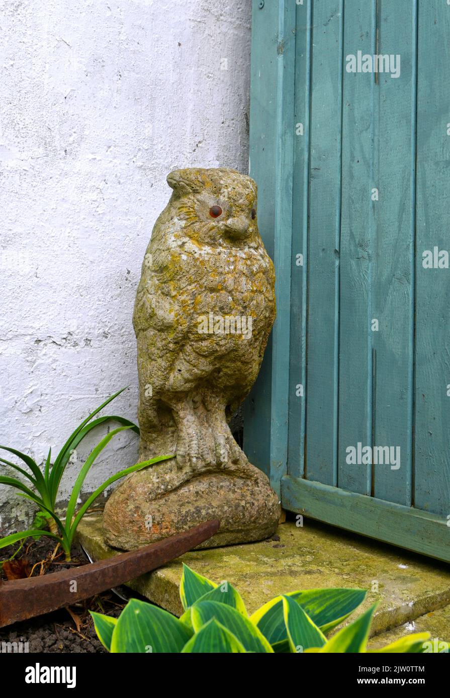 owl statue in corner of garden Stock Photo Alamy