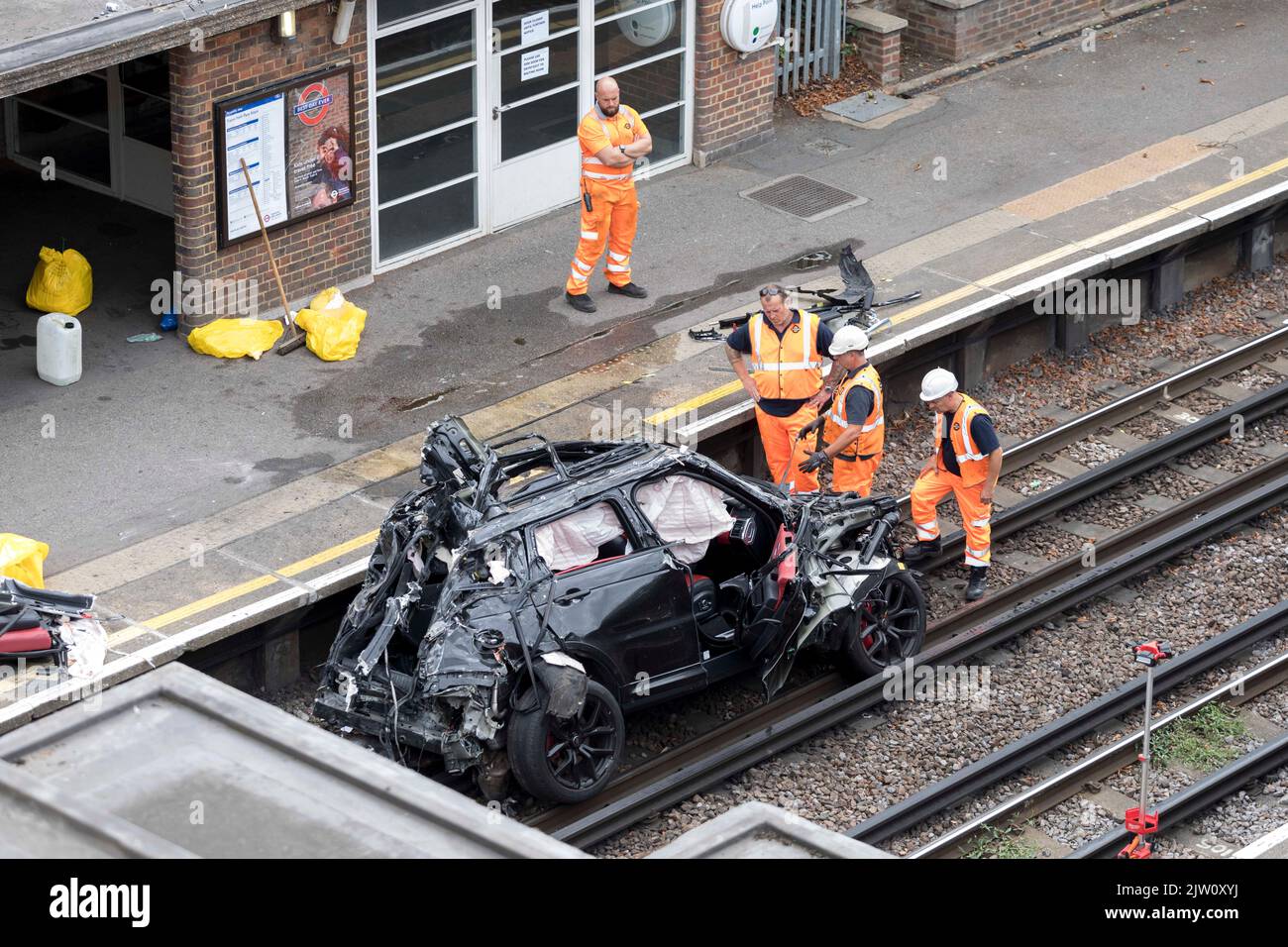A range rover crashed into a tesla in a tesla test centre near Park Royal underground station. The debris of the range rover remains on the tracks of Stock Photo