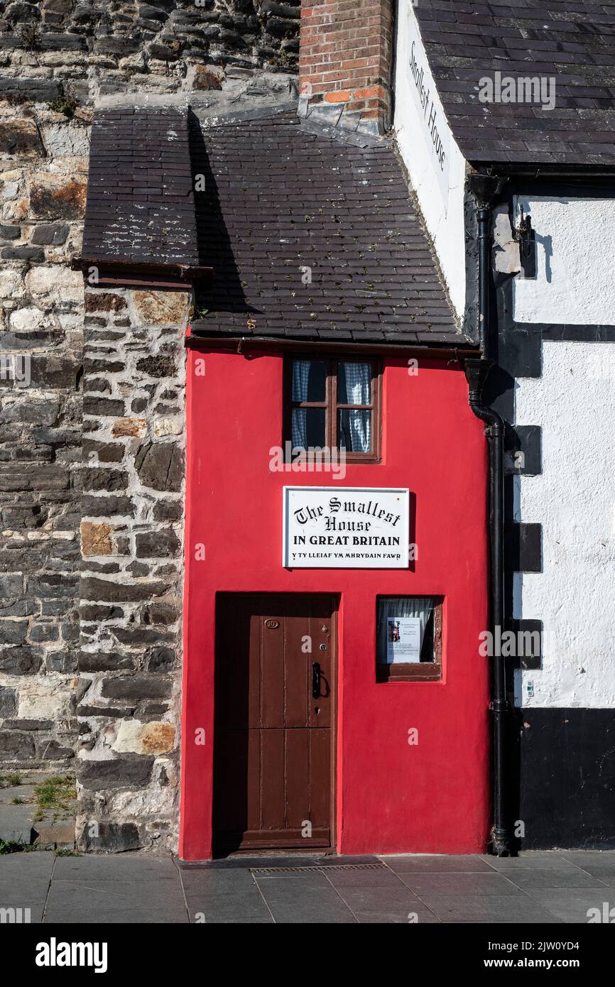 The Smallest House in Great Britain nestled at the end of a terrace on Conwy's quayside being a 72 inches wide by 122 inches high tourist attraction Stock Photo