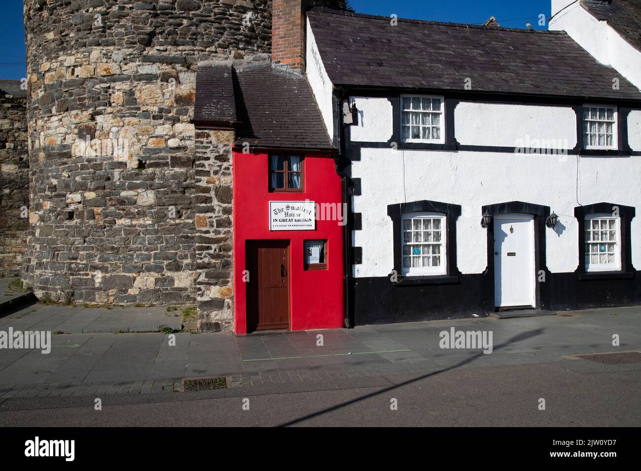 The Smallest House in Great Britain nestled at the end of a terrace on Conwy's quayside being a 72 inches wide by 122 inches high tourist attraction Stock Photo