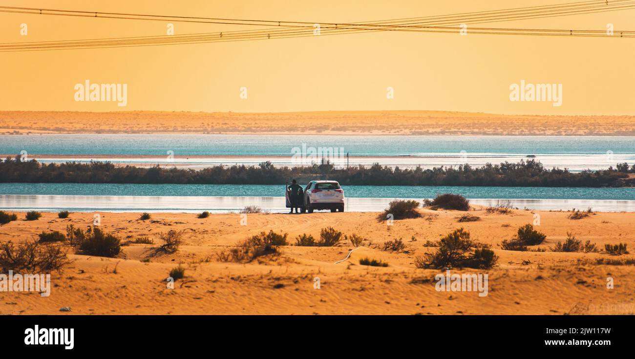 A car on the edge of a desert lake in Al Ahsa, Saudi Arabia. Stock Photo