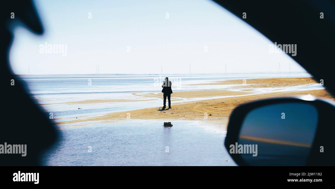 Shadow of man near lake viewed from car window Stock Photo - Alamy