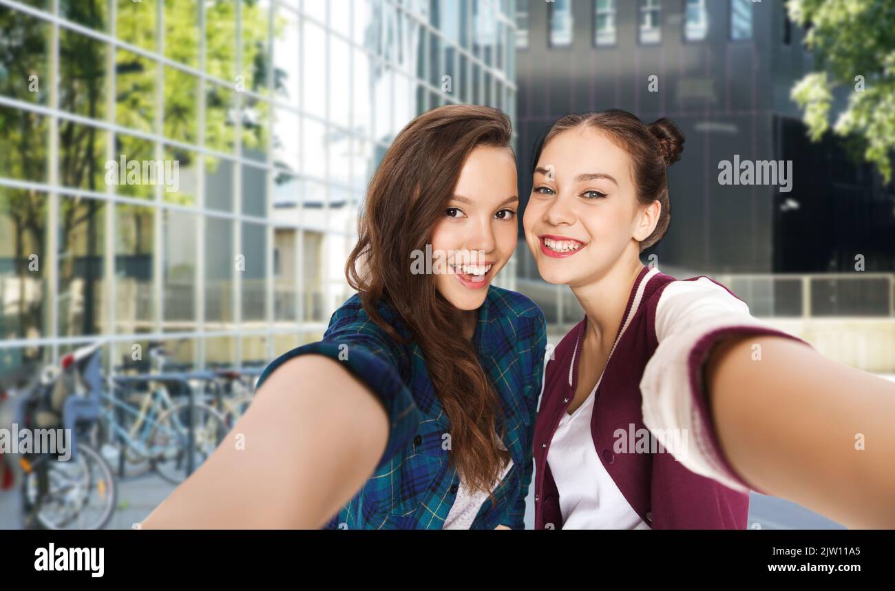 happy teenage girls taking selfie on city street Stock Photo - Alamy