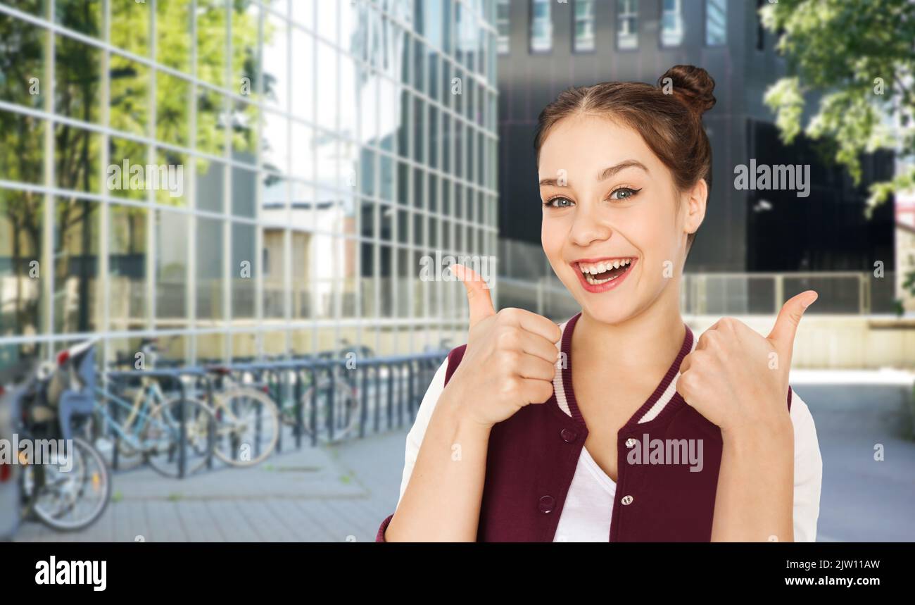happy teenage girl showing thumbs up in city Stock Photo - Alamy