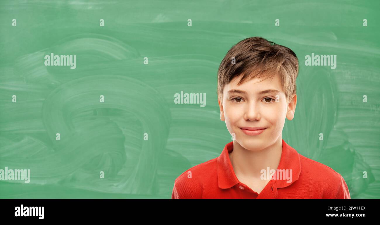 happy student boy over green chalkboard Stock Photo