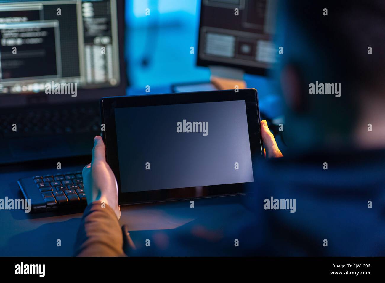 hacker using tablet pc computer for cyber attack Stock Photo