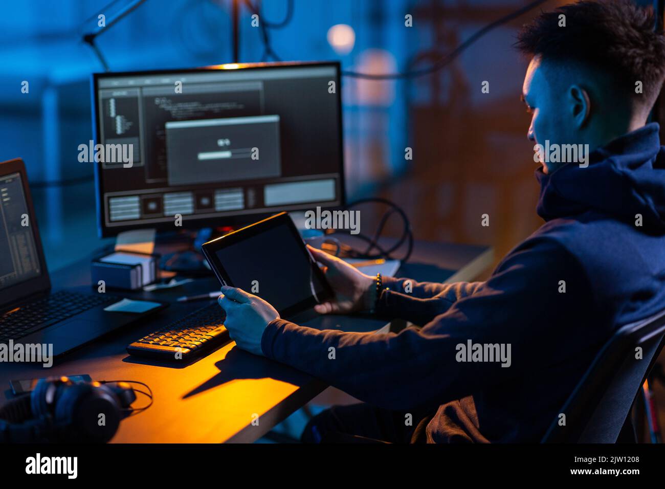 hacker using tablet pc computer for cyber attack Stock Photo
