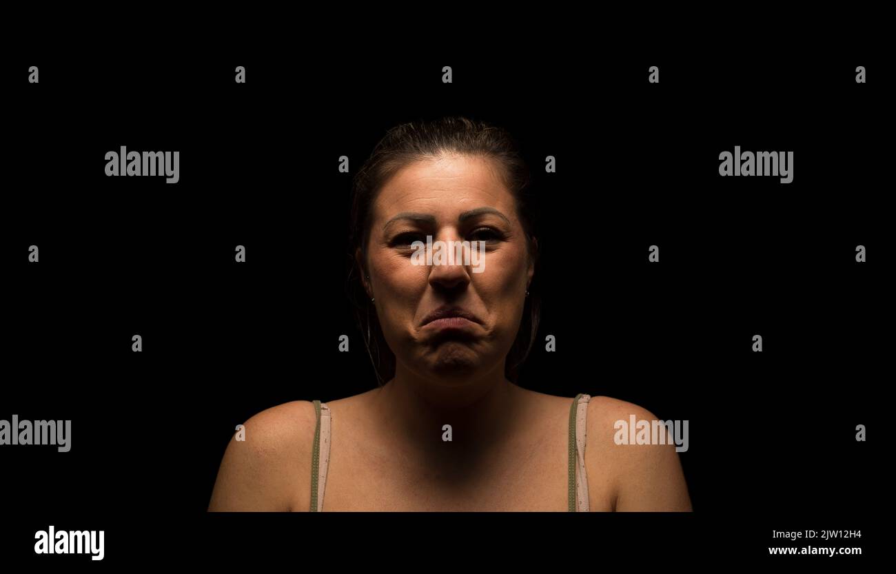 Caucasian female woman looking into camera with a sad looking expression. Stock Photo