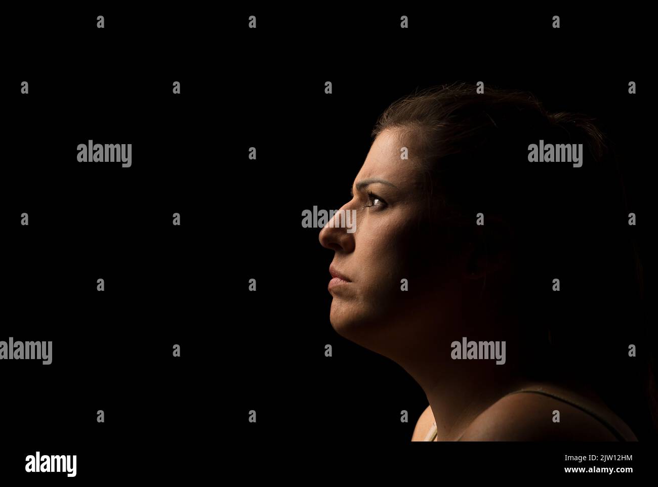 Side shot of a Caucasian female head giving a stern look. Stock Photo