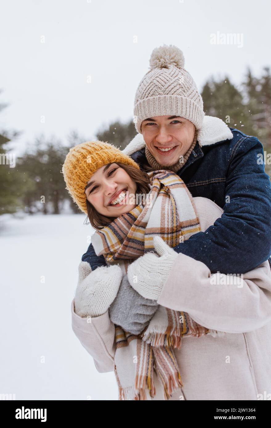happy smiling couple hugging in winter park Stock Photo - Alamy