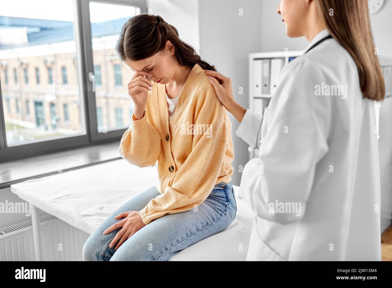 female doctor comforting sad woman at hospital Stock Photo - Alamy