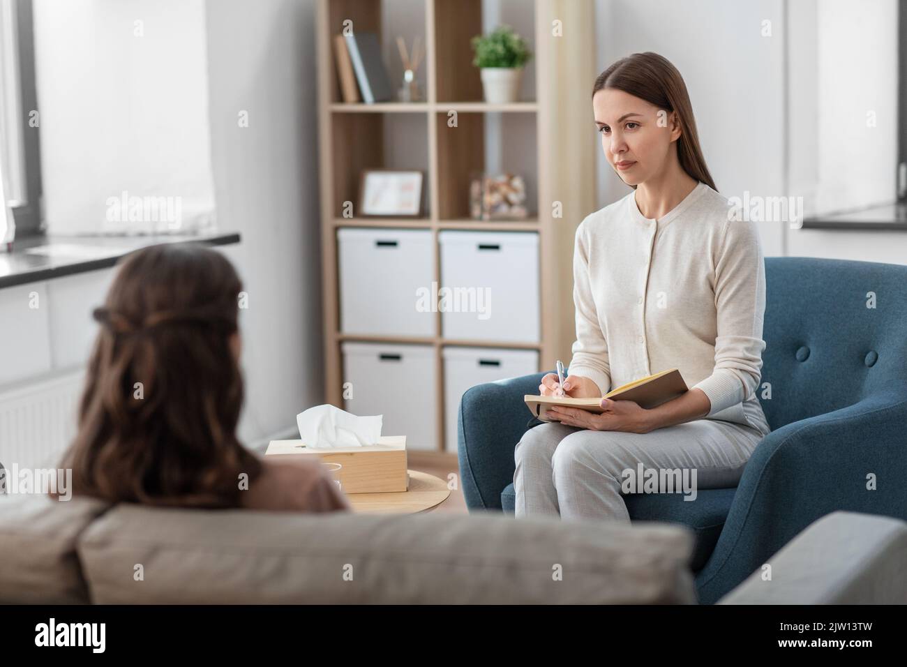psychologist and woman at psychotherapy session Stock Photo