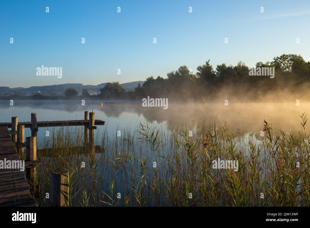 Relaxation and peace at an idyllic and picturesque lake in the middle of the nature reserve in Switzerland. Stock Photo