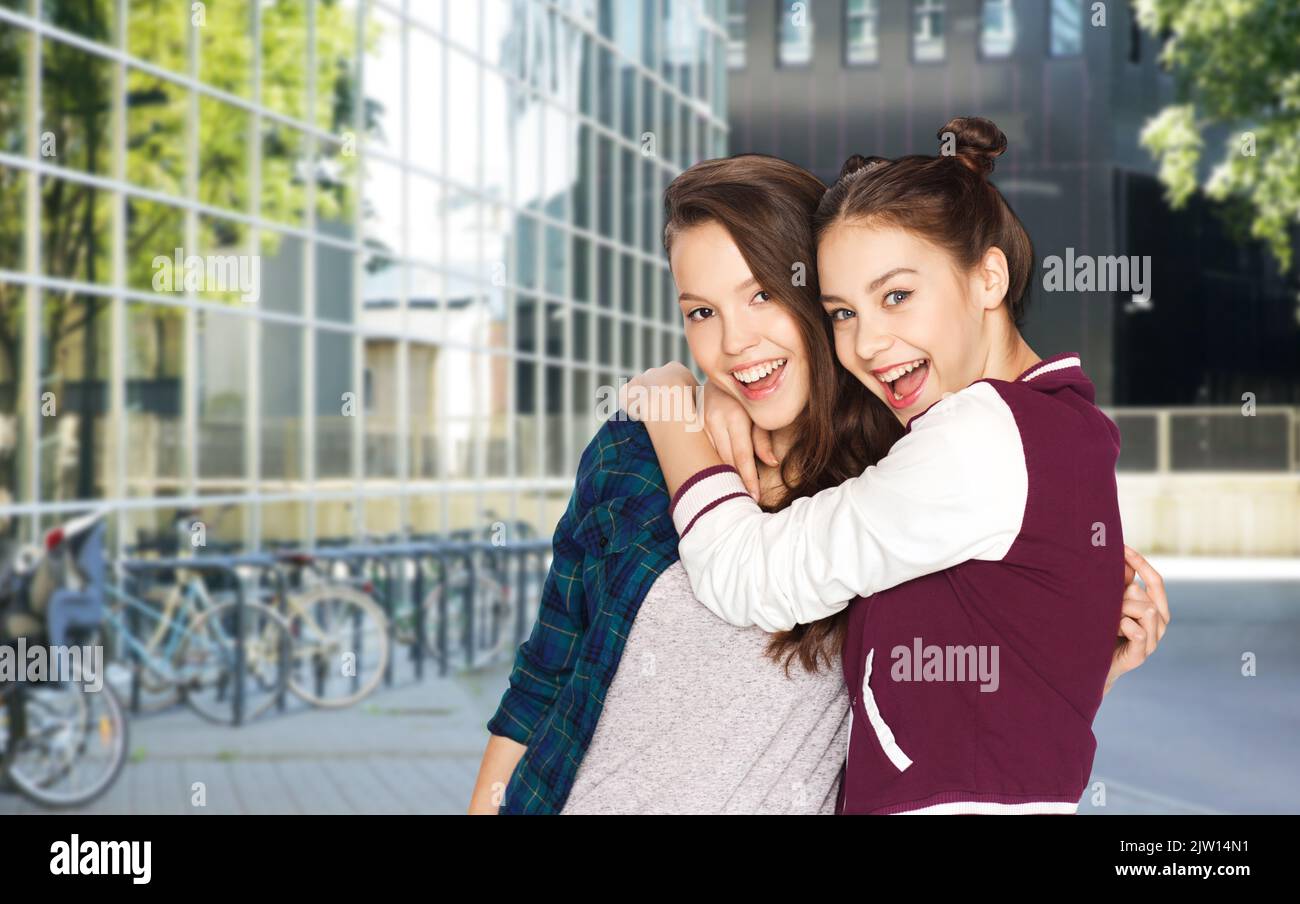 happy smiling teenage girls hugging in city Stock Photo - Alamy