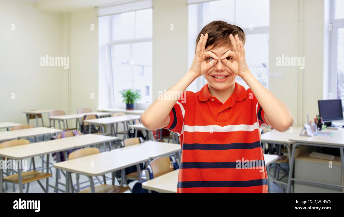 student boy making finger glasses at school Stock Photo