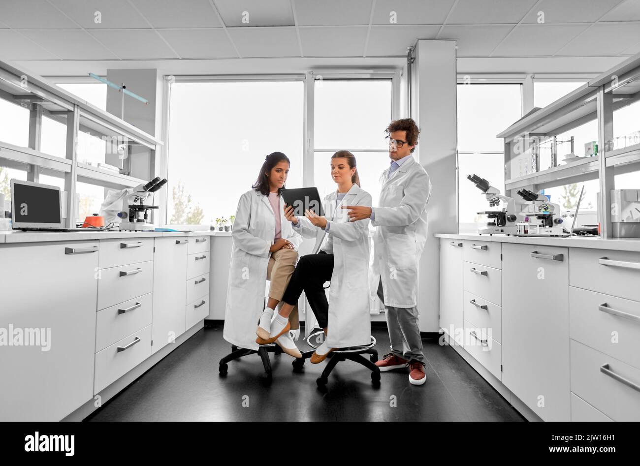 scientists with tablet pc working in laboratory Stock Photo
