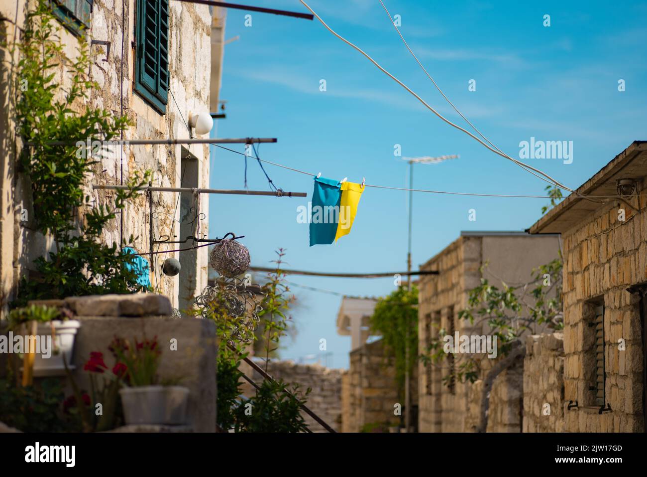 A small flag of Ukraine for support hanging from a rope on the Prvic Island (Sibenik), Croatia Stock Photo