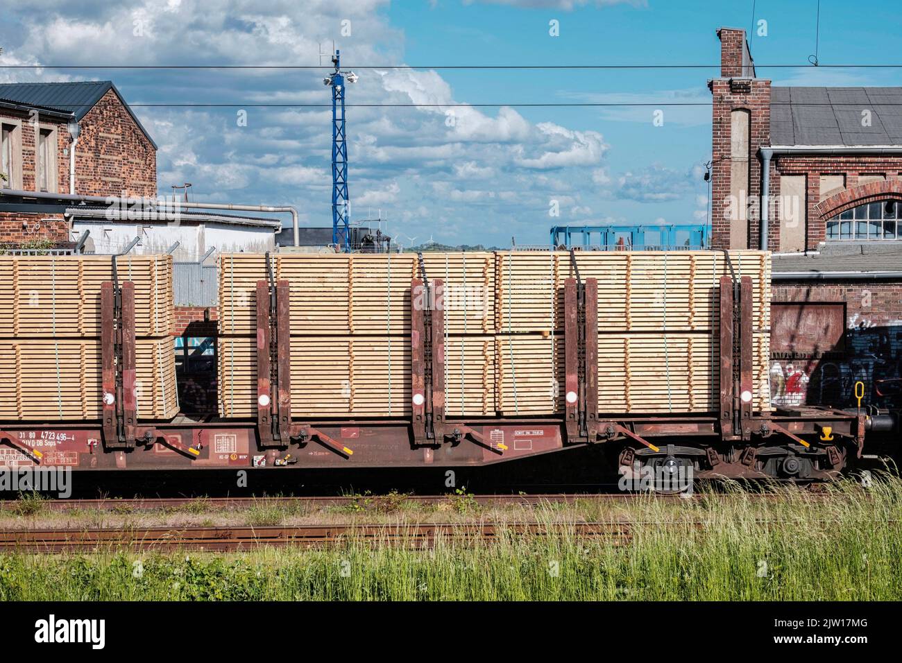 Railway wagon carrying building wood material Stock Photo Alamy