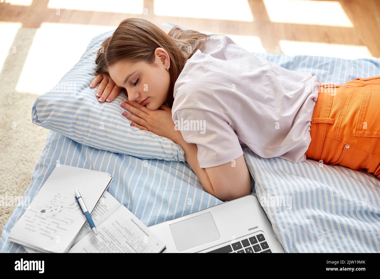 tired student girl with laptop sleeping at home Stock Photo Alamy