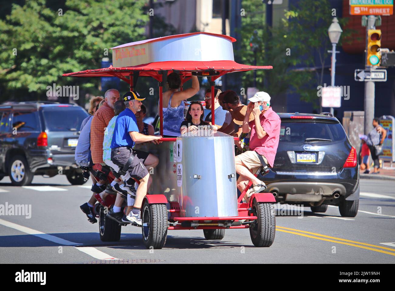 The unique Big Red Pedicycle is a bicycle bus carrying 15 assengers, powered by passengers' pedaling.  Philadelphia, USA - August 2019 Stock Photo