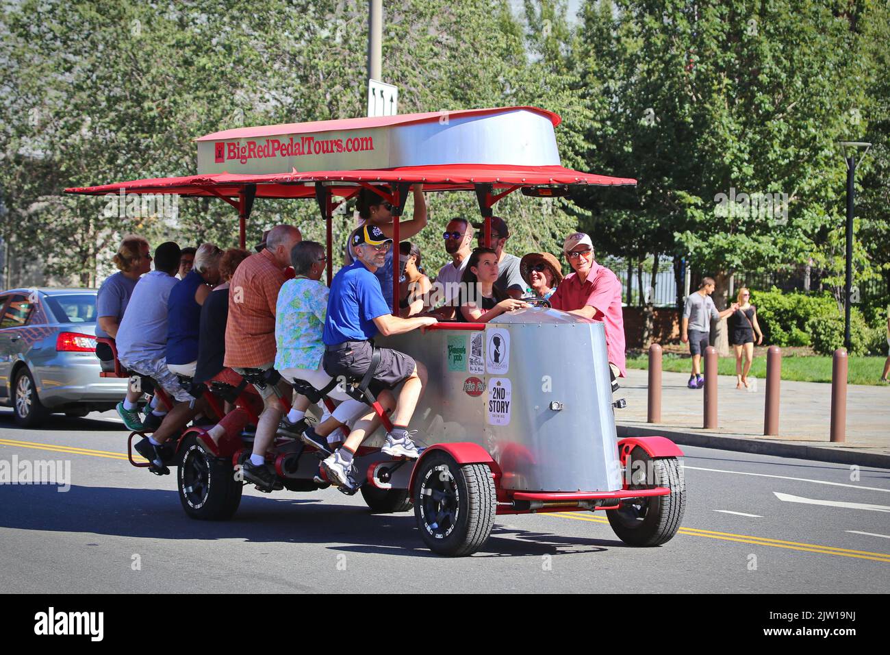 The unique Big Red Pedicycle is a bicycle bus carrying 15 assengers, powered by passengers' pedaling.  Philadelphia, USA - August 2019 Stock Photo