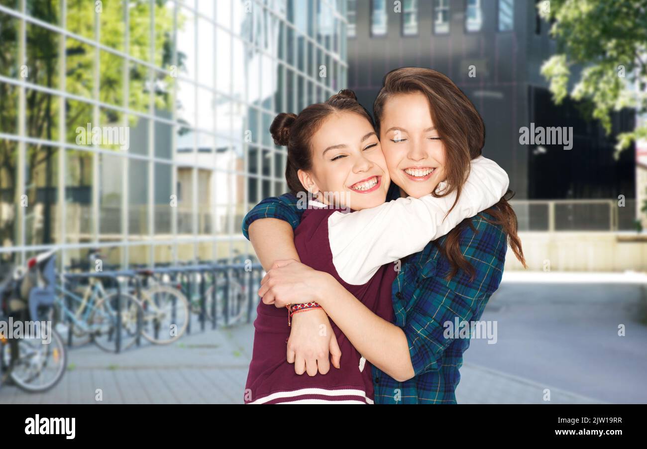 happy smiling teenage girls hugging in city Stock Photo - Alamy