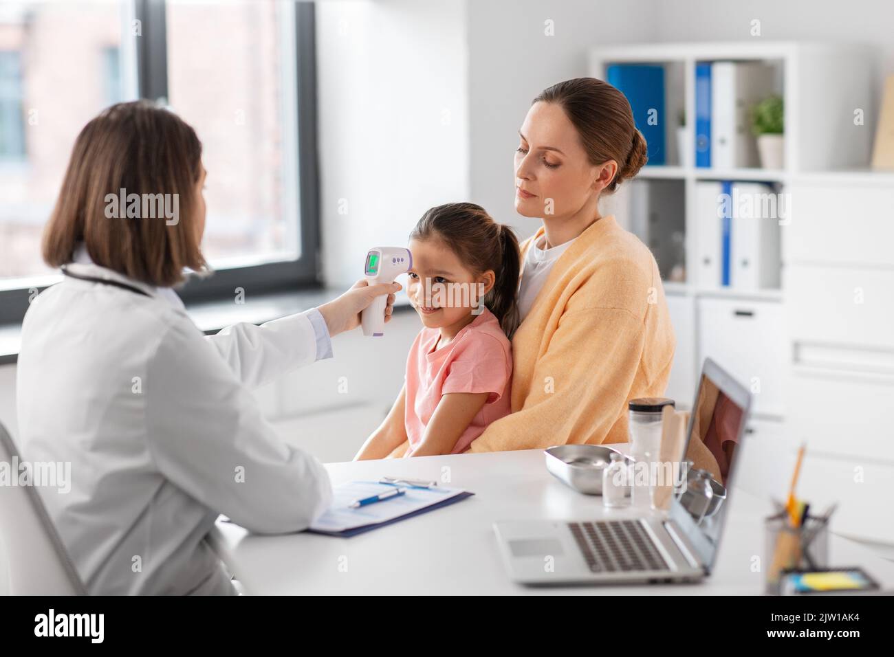 mother with sick daughter and doctor at clinic Stock Photo - Alamy