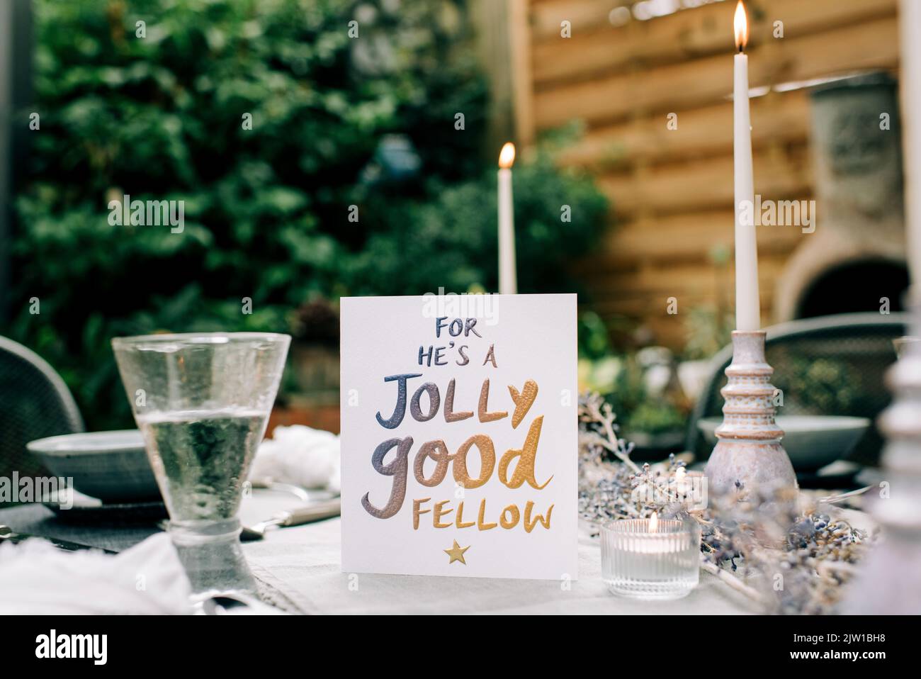 he's a jolly good fellow greeting card on a decorated dinner table Stock Photo