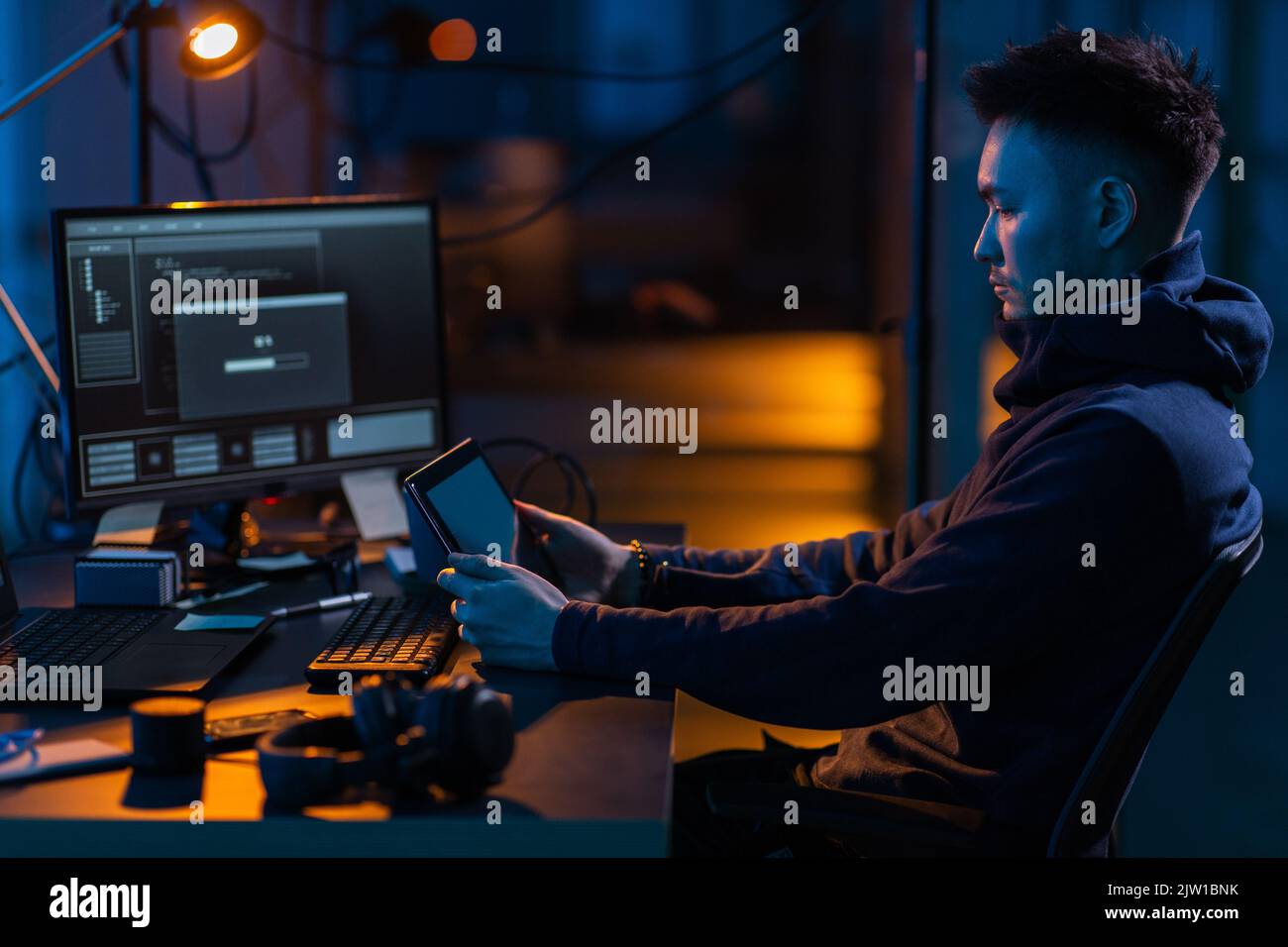 hacker using tablet pc computer for cyber attack Stock Photo
