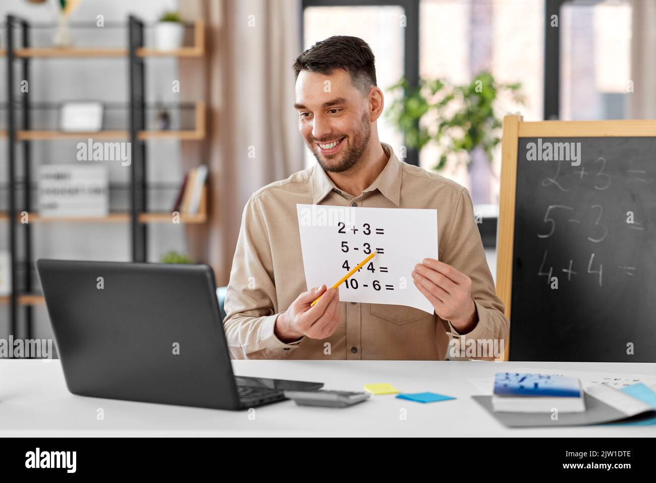 male math teacher having online class at home Stock Photo - Alamy