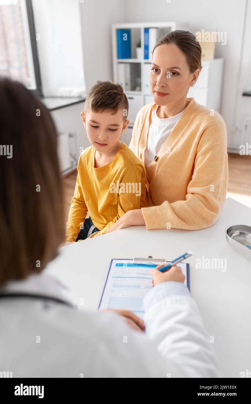 mother, son and doctor talking at clinic Stock Photo - Alamy