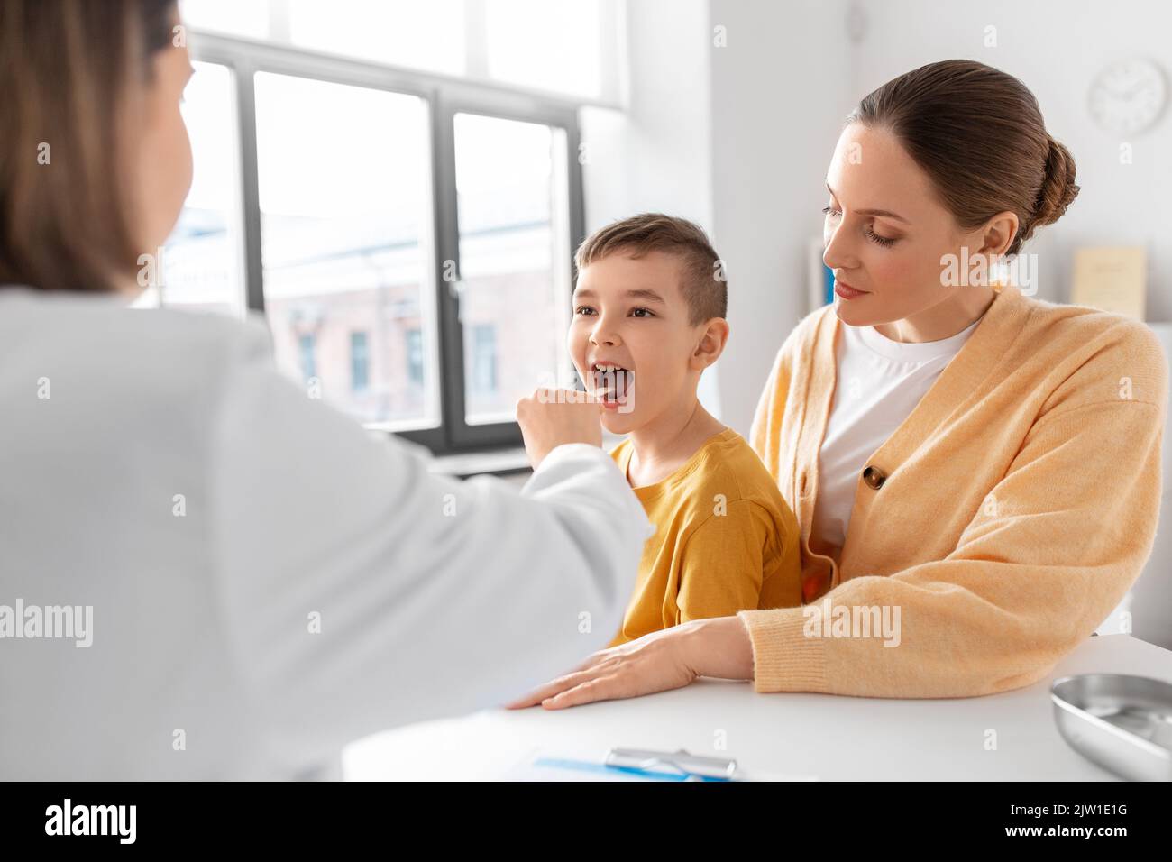 mother, son and doctor checking patient's throat Stock Photo Alamy