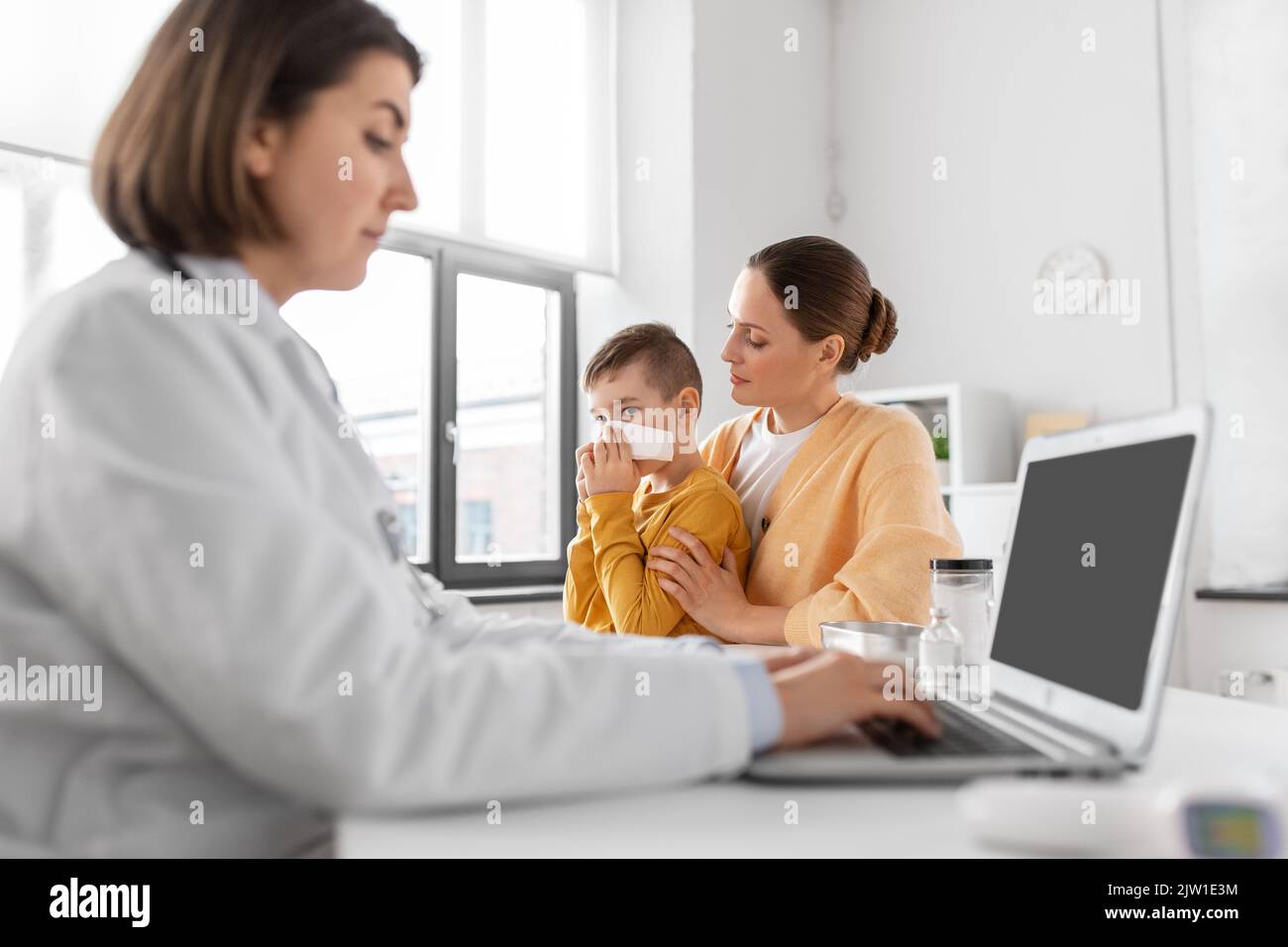 mother, son and doctor with laptop at clinic Stock Photo - Alamy