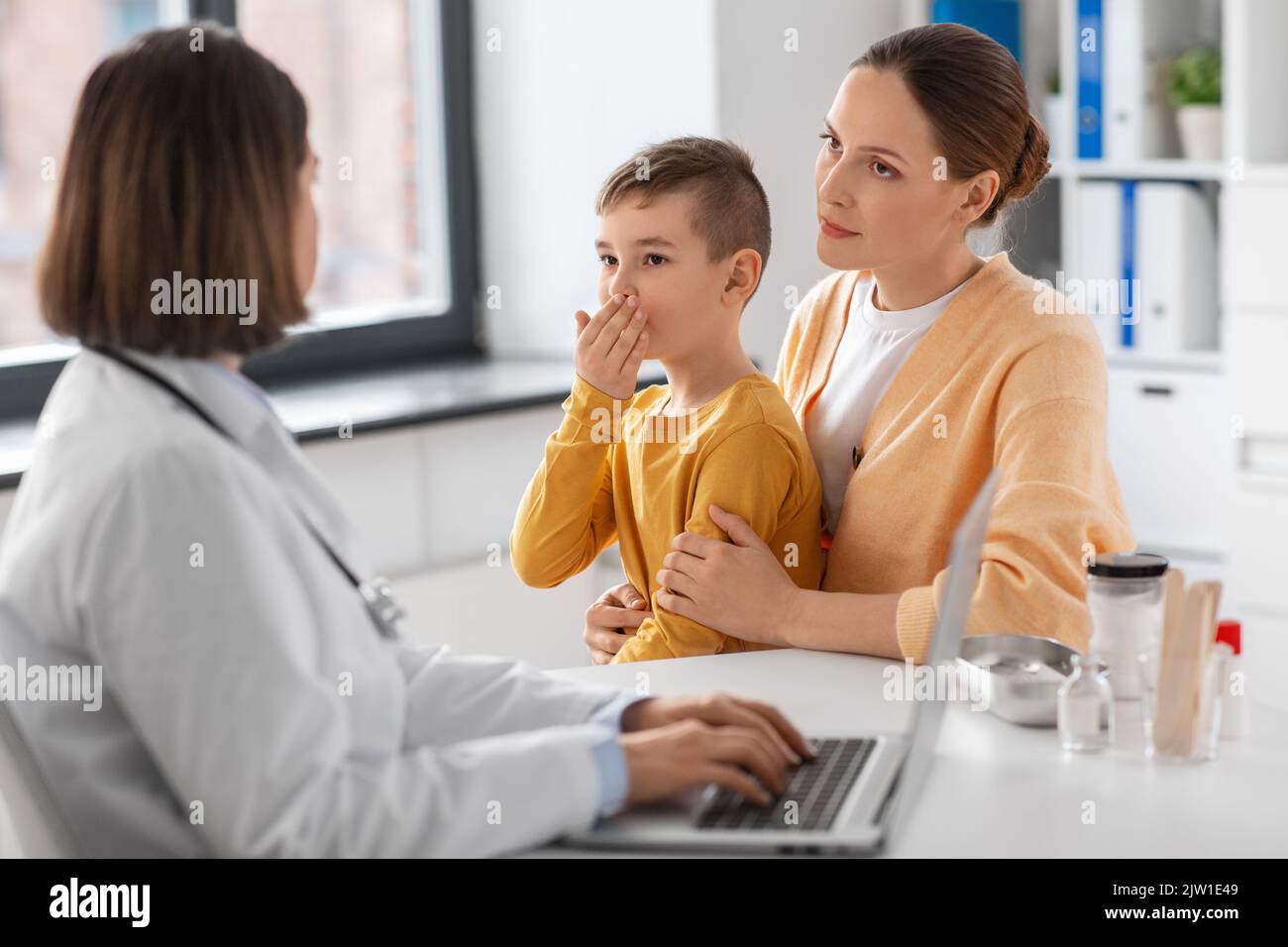mother, son and doctor with laptop at clinic Stock Photo - Alamy