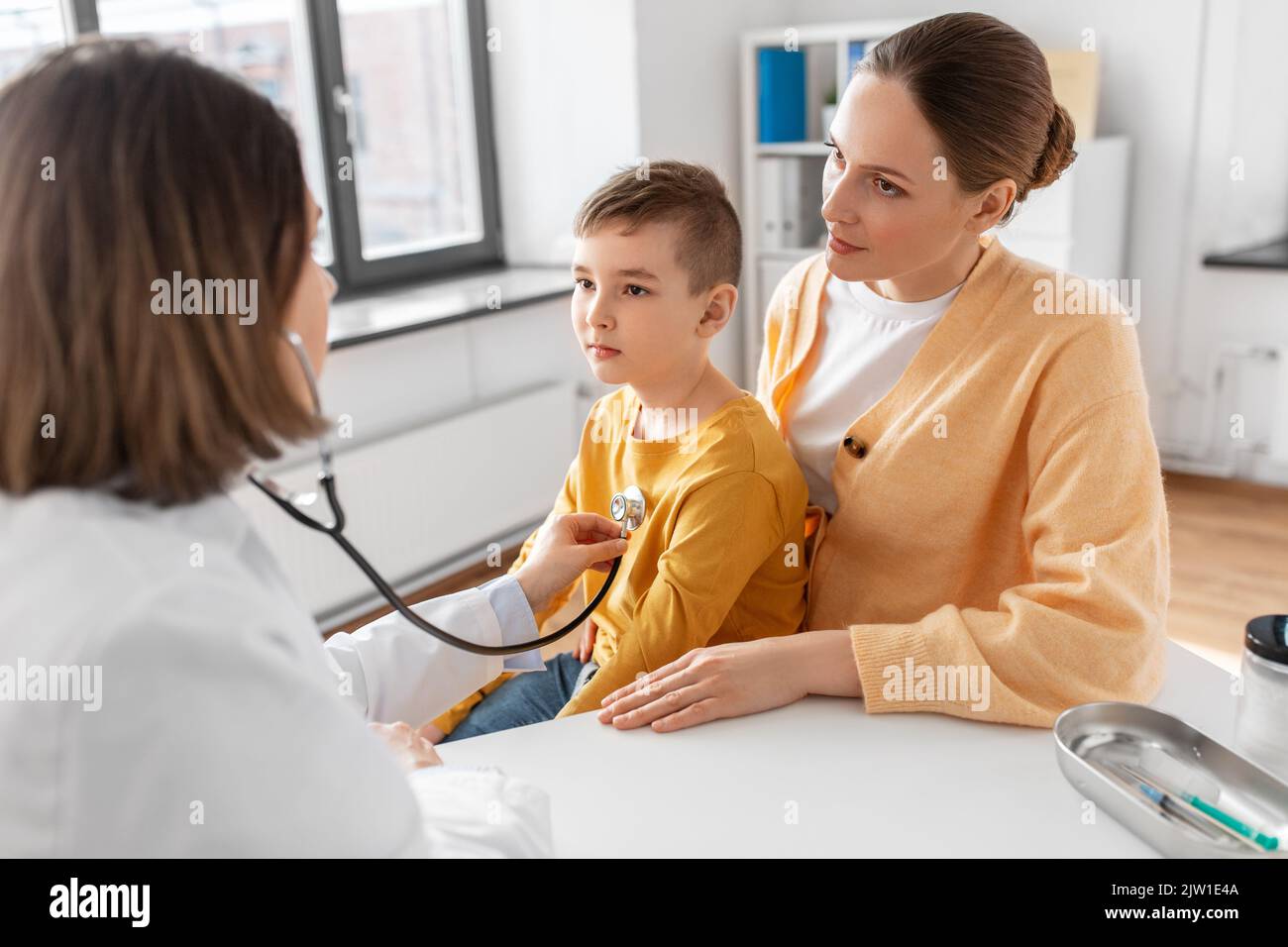 mother, son and doctor with stethoscope at clinic Stock Photo - Alamy