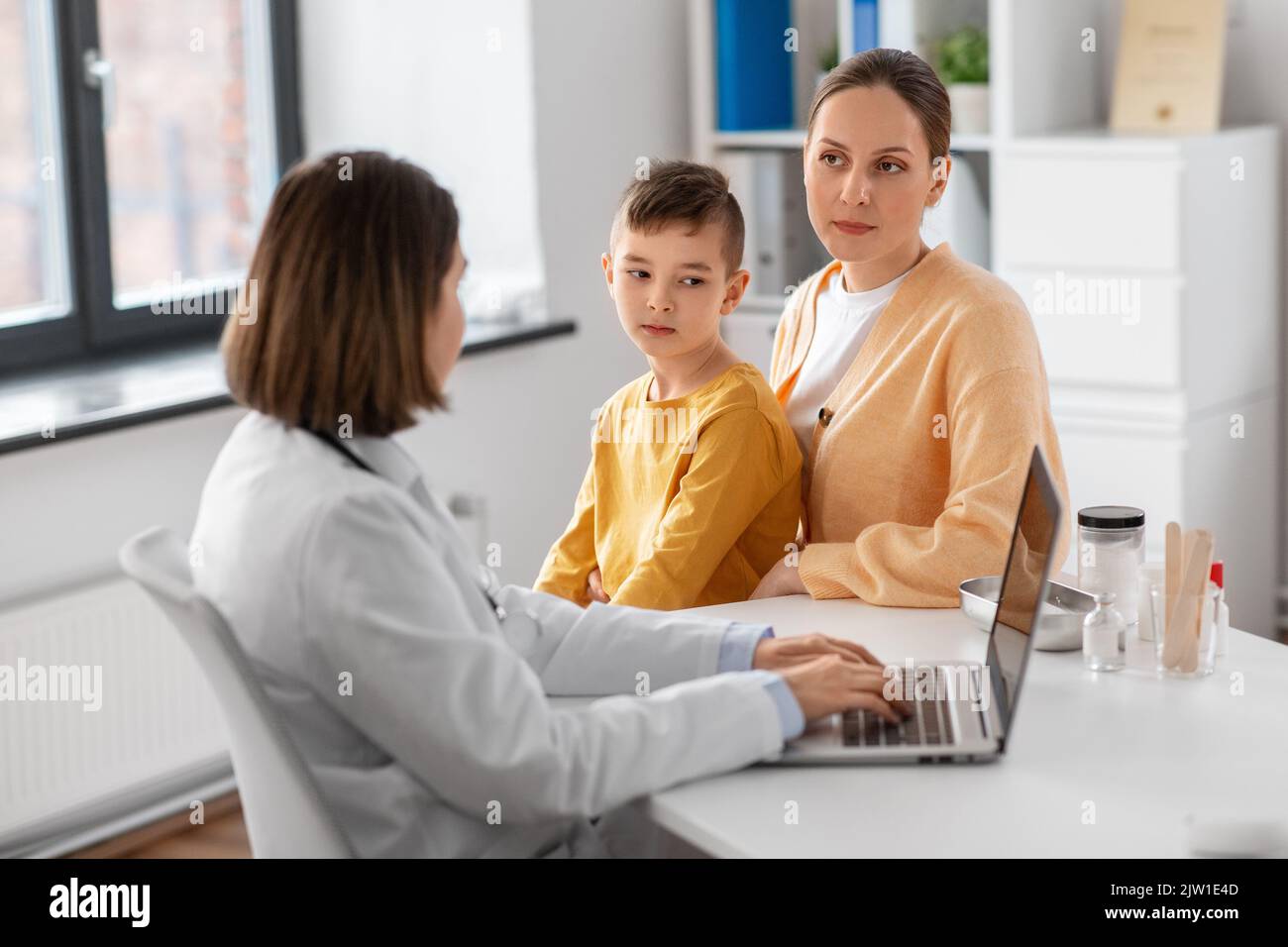 mother, son and doctor with laptop at clinic Stock Photo - Alamy