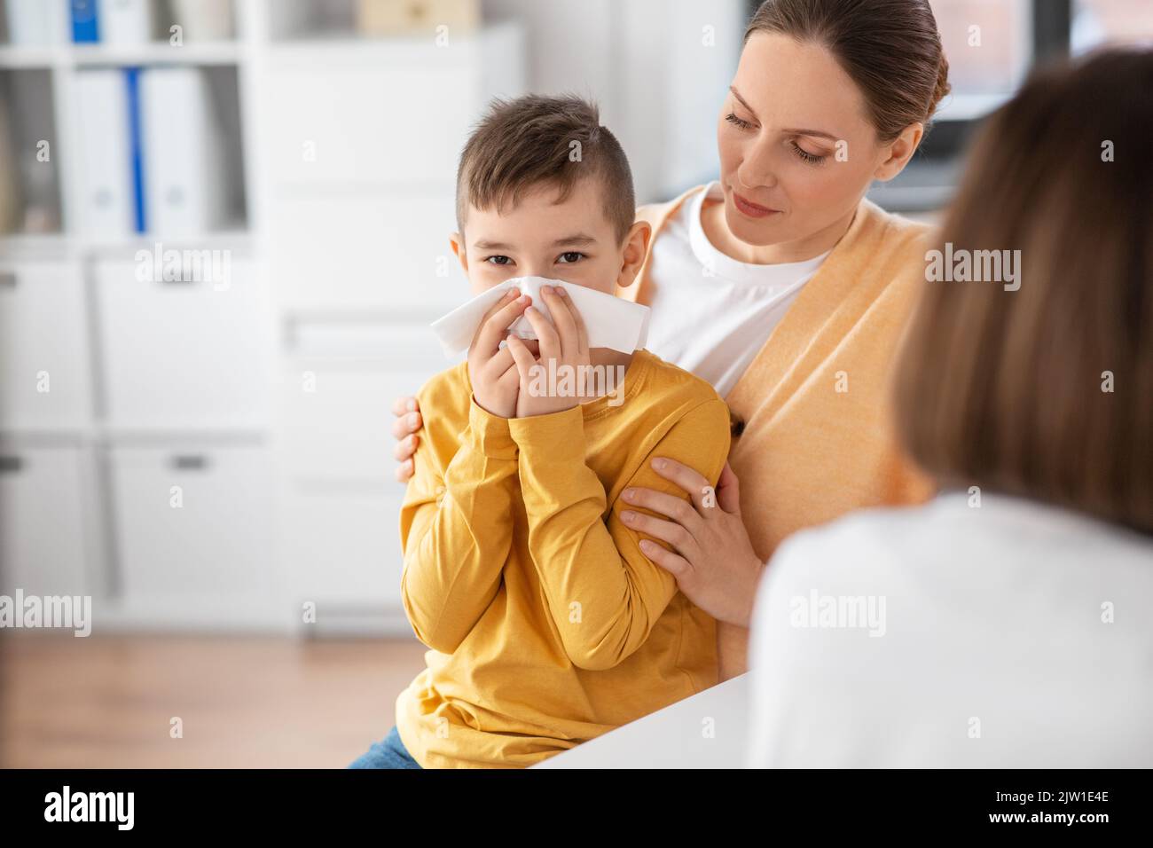 mother, son and doctor with laptop at clinic Stock Photo - Alamy