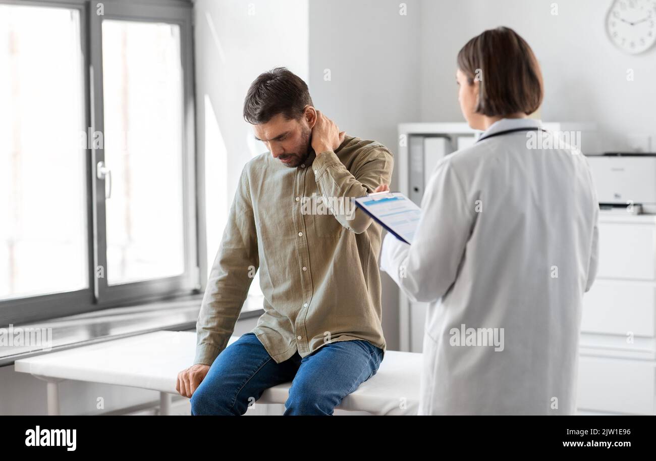 patient with pain in neck and doctor at hospital Stock Photo Alamy