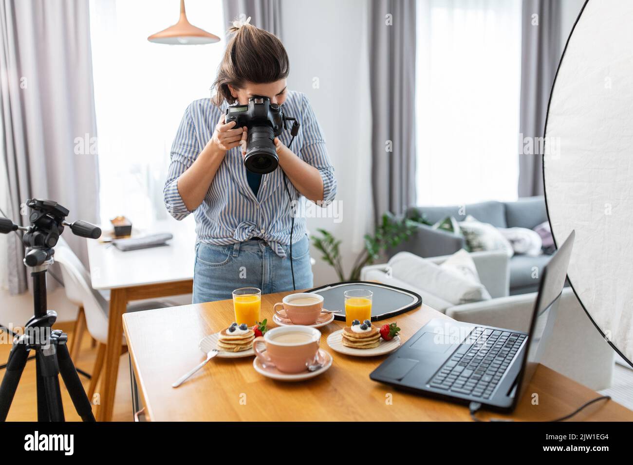 food photographer with camera working in kitchen Stock Photo - Alamy